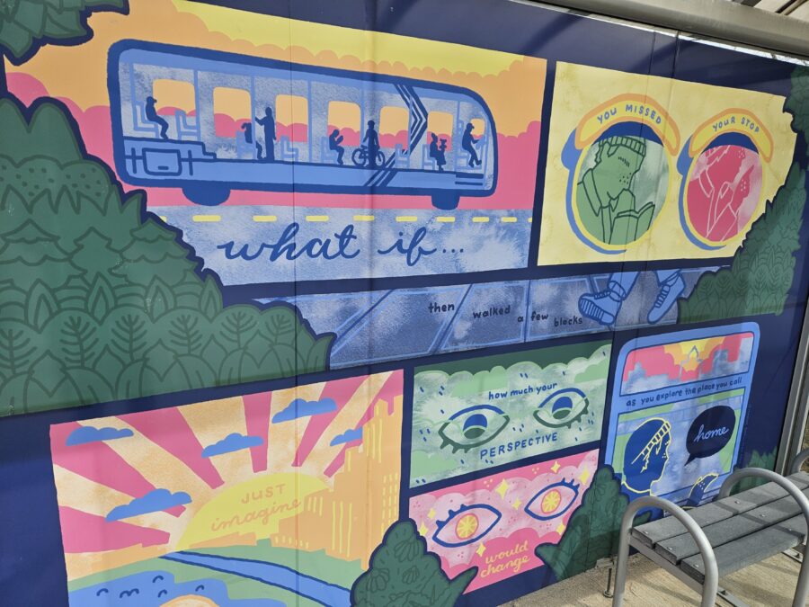 Mural at a bus stop: "What if you missed your stop, then walked a few blocks. Just imagine how much your perspective would change as you explore the place you call home"