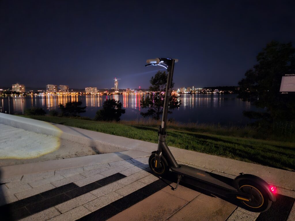 e-scooter at night with Barrie bay and downtown skyline in the background